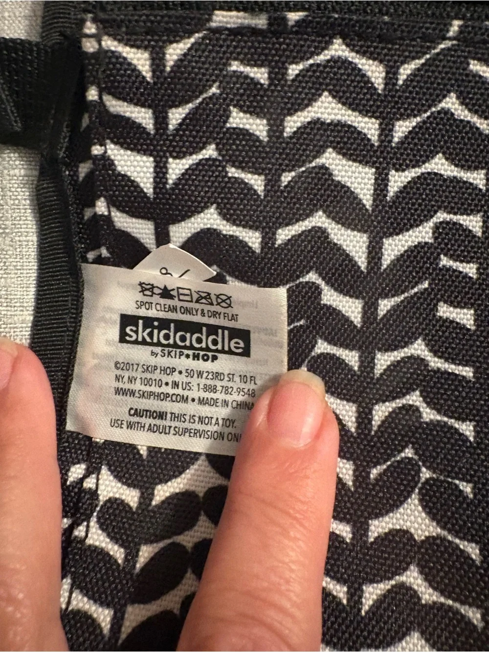 Skidaddle by Skip Hop Black & White Travel diaper bag with fold out changing pad